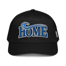 A black baseball cap featuring a blue and silver embroidered 'HOME' design with a wave motif on the front, and a small white VA detail on the side