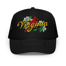 A black trucker-style cap with a curved brim, featuring an embroidered front graphic of a red cardinal, white dogwood flowers, green leaves, and the word 'Virginia' in yellow script