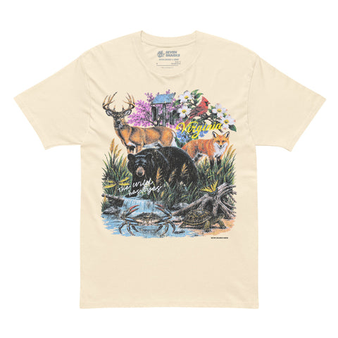 A cream-colored short-sleeve t-shirt featuring a large, colorful front graphic of a forest scene with a deer, bear, fox, and flowers, laid flat against a white background.