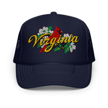 A navy trucker-style cap with a curved brim, featuring an embroidered front graphic of a red cardinal, white dogwood flowers, green leaves, and the word 'Virginia' in yellow script