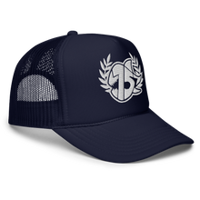 A navy blue FOAM trucker hat with a white embroidered logo on the front, featuring a laurel wreath and SEVEN SHARKS LOGO, set against a plain white background.