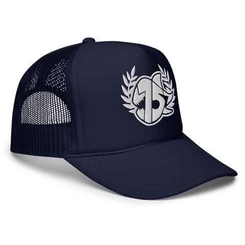 A navy blue FOAM trucker hat with a white embroidered logo on the front, featuring a laurel wreath and SEVEN SHARKS LOGO, set against a plain white background.