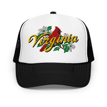 A white and black trucker hat featuring a graphic on the front panel with a red cardinal, white dogwood flowers, green leaves, and the word 'Virginia' in yellow script.