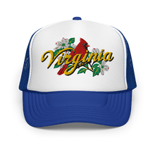 A white and royal trucker hat featuring a graphic on the front panel with a red cardinal, white dogwood flowers, green leaves, and the word 'Virginia' in yellow script.