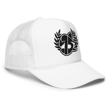 A white trucker hat with white embroidered logo on the front, featuring a laurel wreath and the SEVEN SHARKS logo. The hat has a curved brim and mesh back panels, 