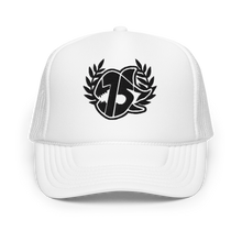 A white trucker hat with white embroidered logo on the front, featuring a laurel wreath and the SEVEN SHARKS logo. The hat has a curved brim and mesh back panels, 