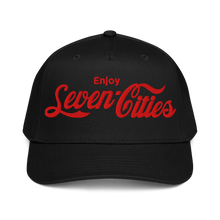 A black baseball cap with red embroidered text reading 'Enjoy Seven Cities' on the front, shown against a plain white background.