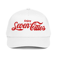 A white baseball cap with red embroidered text reading 'Enjoy Seven Cities' on the front, shown against a plain white background.